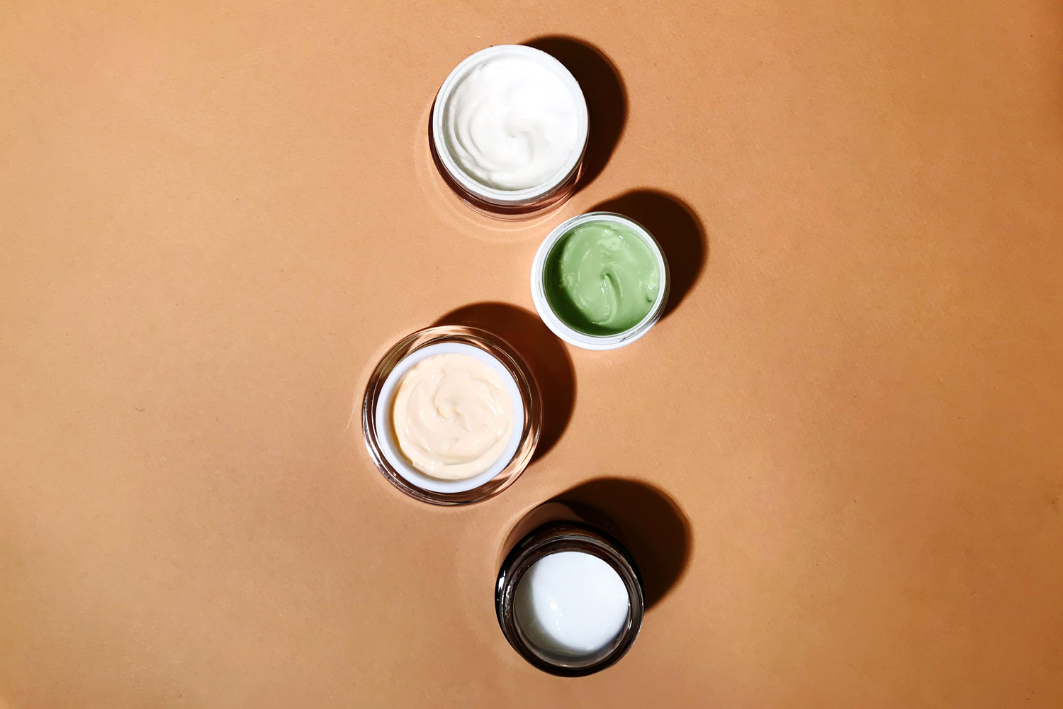 moisturizers with lids open to show texture